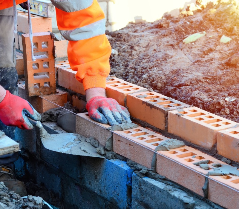 A bricklayer working on a construction site.