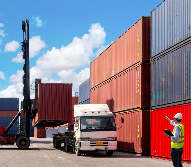 A foreman organising containers from a cargo ship.