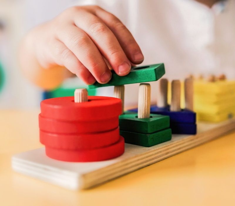 A child playing with wooden shapes.