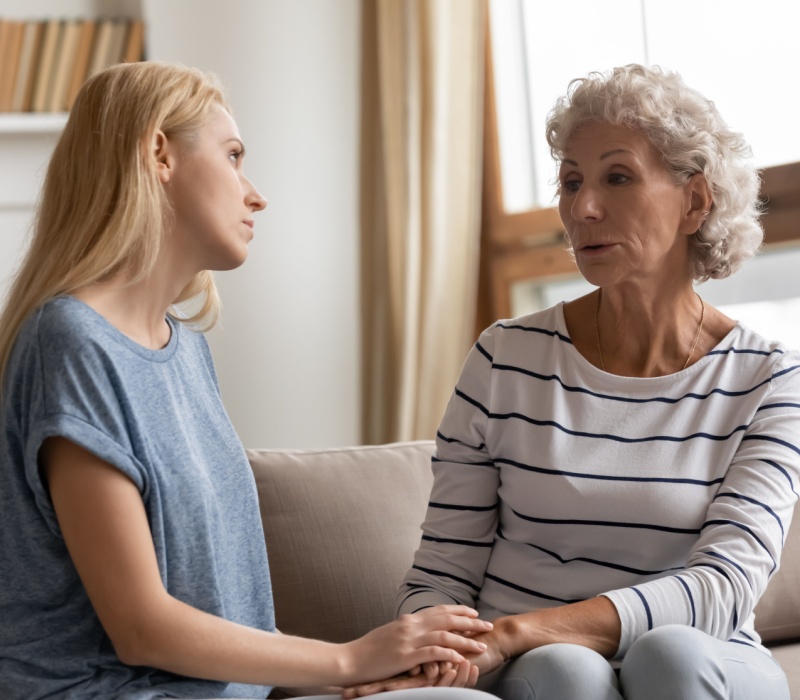 A mother and adult daughter talking.