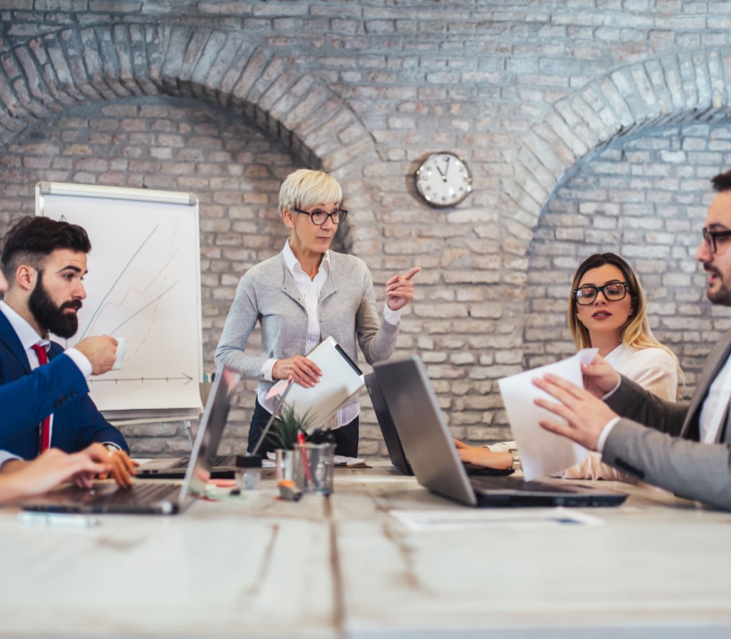 A group of colleagues sitting around a conference table.