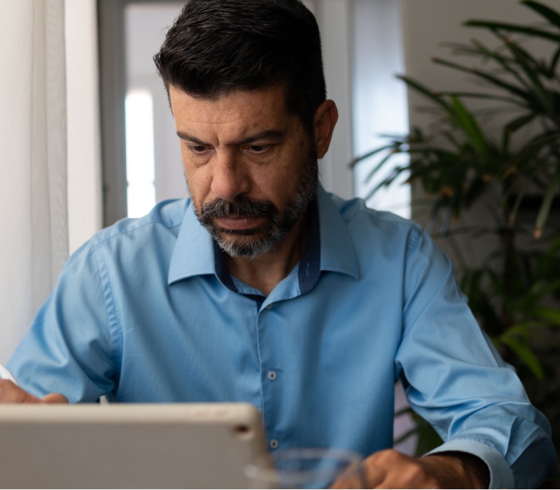 A man looking at a tablet screen.