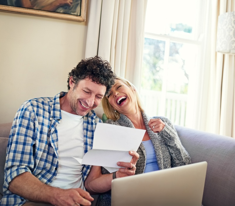 A happy couple reviewing paperwork.