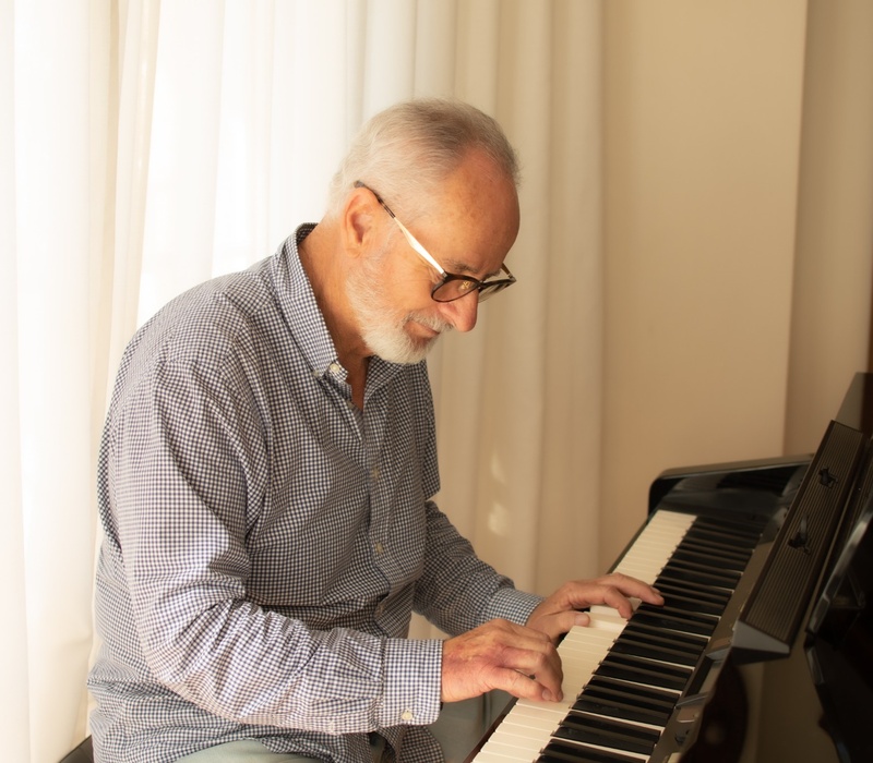 A man practising playing the piano.